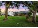 Expansive backyard with lush greenery and a screened pool enclosure creates a serene outdoor retreat at 6020 Kestrel Point Ave, Lithia, FL 33547