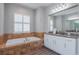This bathroom has dual sinks, a large vanity, a soaking tub, and gorgeous countertops at 6020 Kestrel Point Ave, Lithia, FL 33547