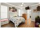 Bright bedroom with a white-washed wood bed frame, ceiling fan, and decorative string lights at 6020 Kestrel Point Ave, Lithia, FL 33547