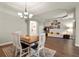 Open dining room with chandelier lighting next to living area with white sofa at 6020 Kestrel Point Ave, Lithia, FL 33547