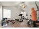Well-lit exercise room featuring a treadmill, elliptical, weight bench, and a ceiling fan at 6020 Kestrel Point Ave, Lithia, FL 33547