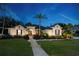 Elegant home exterior at twilight with a landscaped front yard and charming walkway at 6020 Kestrel Point Ave, Lithia, FL 33547