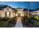 Charming home entrance with a paved walkway, lush landscaping, and inviting front door at 6020 Kestrel Point Ave, Lithia, FL 33547