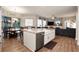 Modern kitchen island with a farmhouse sink, granite countertops, and stainless steel appliances at 6020 Kestrel Point Ave, Lithia, FL 33547