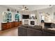 Spacious living room with large windows, a stone fireplace, and hardwood floors at 6020 Kestrel Point Ave, Lithia, FL 33547