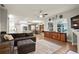 Living room with open floor plan, hardwood flooring, and seamless kitchen/dining access at 6020 Kestrel Point Ave, Lithia, FL 33547