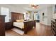 Spacious bedroom features hardwood floors, a large window, and stylish furnishings at 6020 Kestrel Point Ave, Lithia, FL 33547