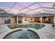 A luxurious screened-in pool with a hot tub offers a private backyard oasis at 6020 Kestrel Point Ave, Lithia, FL 33547