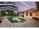 Inviting screened-in pool and spa area with paved patio and outdoor barbecue at 6020 Kestrel Point Ave, Lithia, FL 33547