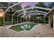 Beautiful screened-in pool and spa area with patterned paver decking at 6020 Kestrel Point Ave, Lithia, FL 33547