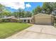 Single-story home featuring a two-car garage and extended driveway on a sunny day at 823 Scenic Heights Dr, Brandon, FL 33511