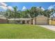 Charming single-story home with a well-maintained lawn, stone accents, and a welcoming front porch at 823 Scenic Heights Dr, Brandon, FL 33511