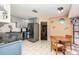 Bright kitchen with blue cabinets, stainless steel appliances, and eat-in dining area at 823 Scenic Heights Dr, Brandon, FL 33511
