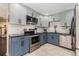 Modern kitchen features blue cabinets, stainless steel appliances and plenty of counter space at 823 Scenic Heights Dr, Brandon, FL 33511