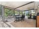 Covered patio with dining table overlooking the backyard, with firepit in the background at 823 Scenic Heights Dr, Brandon, FL 33511