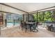 Covered patio with dining table overlooking the pool and wooded backyard at 823 Scenic Heights Dr, Brandon, FL 33511