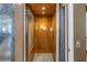 Interior of a residential elevator with a wooden finish and soft lighting at 8755 Commodore Dr, Seminole, FL 33776