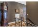 Upper hallway showcasing hardwood floors and decorative iron railing at 8755 Commodore Dr, Seminole, FL 33776