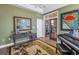 Well-lit office with neutral tones, a desk, and a patterned rug at 8755 Commodore Dr, Seminole, FL 33776