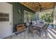 Covered outdoor patio with seating and tropical landscaping in the background at 8755 Commodore Dr, Seminole, FL 33776
