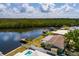 Aerial view featuring waterfront homes with docks along a tranquil canal and beautiful lush green surroundings at 9439 Sun Isle Ne Dr, St Petersburg, FL 33702