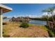 Backyard view of the waterfront property on a sunny day, showcasing the canal and neighboring houses at 9439 Sun Isle Ne Dr, St Petersburg, FL 33702