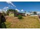 Green home with a spacious backyard featuring lush green grass, a picnic table, and canal access at 9439 Sun Isle Ne Dr, St Petersburg, FL 33702