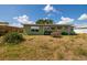 Exterior view of home with back yard and canal access, including a picnic table at 9439 Sun Isle Ne Dr, St Petersburg, FL 33702