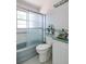 Modest bathroom featuring a bathtub and shower combo, toilet, and sink with green countertop at 9439 Sun Isle Ne Dr, St Petersburg, FL 33702
