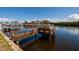 Wooden boat dock on the canal, offering a picturesque view of the surrounding waterfront at 9439 Sun Isle Ne Dr, St Petersburg, FL 33702