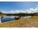 Exterior image featuring a wooden dock extending into the canal, offering scenic waterfront views at 9439 Sun Isle Ne Dr, St Petersburg, FL 33702