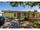 Charming home featuring a neatly landscaped front yard and a welcoming entrance at 9439 Sun Isle Ne Dr, St Petersburg, FL 33702