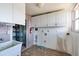 Laundry room with ample storage, utility sink, and washer/dryer hookups at 9439 Sun Isle Ne Dr, St Petersburg, FL 33702