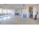 Spacious living room awaiting renovation with large windows, offering ample natural light and potential at 9439 Sun Isle Ne Dr, St Petersburg, FL 33702