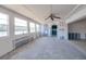 Bright living room with views of the waterfront from a wall of windows awaiting remodel at 9439 Sun Isle Ne Dr, St Petersburg, FL 33702
