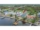 Waterfront home featuring a private dock, lush landscaping, and serene water views at 1022 Canal St, Ruskin, FL 33570