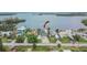 Waterfront home featuring a private dock, lush landscaping, and serene water views at 1022 Canal St, Ruskin, FL 33570