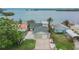 Street view of a charming home featuring lush landscaping, and a spacious driveway at 1022 Canal St, Ruskin, FL 33570