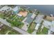 Aerial view of a home with lush landscaping, and a private dock at 1022 Canal St, Ruskin, FL 33570