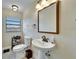 Cozy bathroom with modern fixtures, a pedestal sink, and a window that brings in natural light at 1022 Canal St, Ruskin, FL 33570