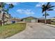View of the detached one car garage with a white door and a driveway at 1022 Canal St, Ruskin, FL 33570