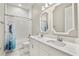 Well-lit bathroom with double vanity, tub-shower, and modern fixtures at 13038 Paddock Woods Pl, Riverview, FL 33579