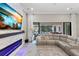 Comfortable living room with an electric fireplace, a large sofa, and outdoor pool view at 13038 Paddock Woods Pl, Riverview, FL 33579