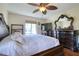 Serene main bedroom with a large bed, dresser, and a ceiling fan for added comfort, providing a peaceful retreat at 1488 Pine Glen Ln # B2, Tarpon Springs, FL 34688