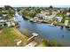 Waterfront property with a private dock offers stunning views of a serene canal, perfect for boating and relaxation at 14928 Capri Ln, Hudson, FL 34667