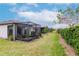 Wide backyard showcasing a screened patio, lush greenery, and well-maintained lawn at 19367 Coastal Shore Ter, Land O Lakes, FL 34638