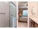 Walk-in shower and bathroom featuring a view to the primary bedroom at 19367 Coastal Shore Ter, Land O Lakes, FL 34638