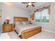 Tranquil bedroom featuring a large window, wood furnishings, and decorative accents at 19367 Coastal Shore Ter, Land O Lakes, FL 34638