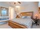 Serene main bedroom suite with a decorative bench, en-suite bathroom, and elegant furnishings at 19367 Coastal Shore Ter, Land O Lakes, FL 34638