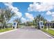 Gated community entrance with manicured landscaping and secure access at 19367 Coastal Shore Ter, Land O Lakes, FL 34638